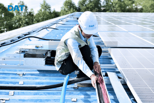 Technician using tools to install solar panels collaboratively
