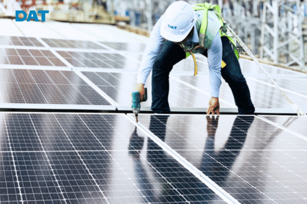 Technician inspecting and testing solar panel installation