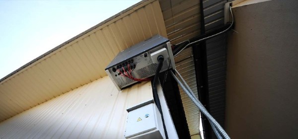 Solar Power Inverter Mounted on Exterior Wall with Protective Enclosure